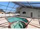 Screened-in pool features connecting spa, brick trim, and backyard access at 489 Bohannon Blvd, Orlando, FL 32824