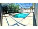 Relaxing screened-in pool and spa with mature landscaping, ideal for private outdoor leisure at 489 Bohannon Blvd, Orlando, FL 32824