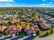 Aerial view features the home's tile roof, attached garage, community landscaping, and pond at 5049 Harbour Dr # 1, Oxford, FL 34484