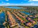 Beautiful aerial view of neighborhood homes with lake, water features, and manicured landscaping at 5049 Harbour Dr # 1, Oxford, FL 34484