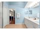 Bathroom showing double vanity, mirror and doorway to bedroom at 5049 Harbour Dr # 1, Oxford, FL 34484