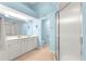 Bathroom with double vanity, walk-in shower, and light blue walls at 5049 Harbour Dr # 1, Oxford, FL 34484