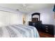 Comfortable bedroom features a closet, TV, hardwood floors and a ceiling fan at 5049 Harbour Dr # 1, Oxford, FL 34484