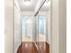 Hallway showing access to a bedroom and bathroom with mirrored closet doors at 5049 Harbour Dr # 1, Oxford, FL 34484