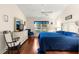 Bright main bedroom featuring a white dresser, rocking chair, and large window at 5049 Harbour Dr # 1, Oxford, FL 34484