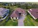 A high angle shot showcases this lovely home, manicured lawn, and brick paver driveway at 5413 Sandy Hill Ln, Lady Lake, FL 32159