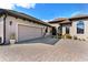 This house features an attached garage with brick paver driveway and manicured landscaping at 5413 Sandy Hill Ln, Lady Lake, FL 32159