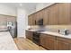 This modern kitchen features wood cabinets, stainless steel appliances, and light countertops at 5413 Sandy Hill Ln, Lady Lake, FL 32159