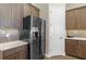 This kitchen includes stainless steel appliances, light countertops, and stylish wood cabinets at 5413 Sandy Hill Ln, Lady Lake, FL 32159