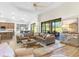 This living room features a large, comfortable seating area with views of the screened-in lanai at 5413 Sandy Hill Ln, Lady Lake, FL 32159