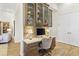 Home office area featuring a built-in desk, display cabinets, neutral color palette, and tile floors for a comfortable workspace at 5413 Sandy Hill Ln, Lady Lake, FL 32159