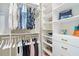 Well-organized walk-in closet with custom shelving, hanging rods, drawers, and accessories, providing ample storage space at 5413 Sandy Hill Ln, Lady Lake, FL 32159