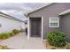 Home exterior featuring a covered front entrance, clean lines and tidy landscaping at 5597 Gracie Ln, The Villages, FL 32163