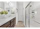 Bathroom with a double sink vanity, walk-in shower, and modern fixtures at 6051 Chase Ct, The Villages, FL 32163