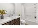 Bright bathroom featuring a shower-tub combo, framed mirror, and dark wood vanity with a white countertop at 6051 Chase Ct, The Villages, FL 32163