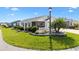 Charming single-story home with manicured lawn, mature landscaping, and a screened front porch at 6051 Chase Ct, The Villages, FL 32163