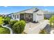 Nicely landscaped white home with a screened in lanai and white picket fence at 6051 Chase Ct, The Villages, FL 32163