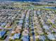 Aerial view showcases a meticulously planned community with lush green landscaping and varied homes at 610 Mallory Hill Dr, The Villages, FL 32162