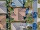 Birds eye view features concrete driveway, mature landscaping, and brown shingle roof at 610 Mallory Hill Dr, The Villages, FL 32162