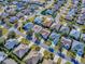 An aerial view showcases homes in a well-planned neighborhood with mature trees at 610 Mallory Hill Dr, The Villages, FL 32162