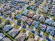 An aerial view showcases homes in a well-planned neighborhood with mature trees at 610 Mallory Hill Dr, The Villages, FL 32162