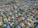 Aerial view showing a neighborhood featuring lakes, a golf course, and numerous homes at 610 Mallory Hill Dr, The Villages, FL 32162