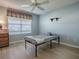 Guest bedroom with a ceiling fan, window and wood-look flooring at 610 Mallory Hill Dr, The Villages, FL 32162