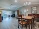 Dining area with patio view and sleek floors open to the comfortable living room at 610 Mallory Hill Dr, The Villages, FL 32162