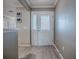 Inviting entryway featuring a glass-paneled front door and light-colored wood-look flooring at 610 Mallory Hill Dr, The Villages, FL 32162