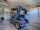 Garage features a golf cart with rear storage and a convenient design at 610 Mallory Hill Dr, The Villages, FL 32162