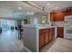 Bright kitchen featuring wood cabinets and a view to the living space beyond at 610 Mallory Hill Dr, The Villages, FL 32162