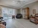 Bright living room with sliding doors to the patio, ceiling fan and modern wood flooring at 610 Mallory Hill Dr, The Villages, FL 32162