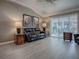 Comfortable living room with leather sofa, ceiling fan, and sliding glass doors leading to a patio at 610 Mallory Hill Dr, The Villages, FL 32162