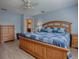 The spacious main bedroom has a ceiling fan and lots of space for relaxation at 610 Mallory Hill Dr, The Villages, FL 32162