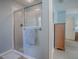 Glass shower with a neutral tile surround, towel rack and shower head at 610 Mallory Hill Dr, The Villages, FL 32162