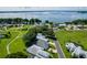 Scenic aerial of a residential area next to a lake, showcasing well-maintained lawns and community spaces at 6250 Sailboat Ave, Tavares, FL 32778