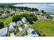 Aerial view of homes near the water showcasing beautiful landscaping and waterfront community at 6250 Sailboat Ave, Tavares, FL 32778