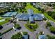 Aerial view featuring a clubhouse, pool, tennis courts, landscaping, and parking at 6250 Sailboat Ave, Tavares, FL 32778