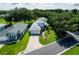 Aerial view of a beautiful home with a well-manicured lawn and lush landscaping at 6250 Sailboat Ave, Tavares, FL 32778