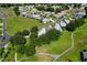 An aerial view showcases the neighborhood with lush green spaces and well-maintained homes at 6250 Sailboat Ave, Tavares, FL 32778