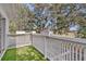 Outdoor balcony area with green carpet and white railings surrounded by lush trees at 6250 Sailboat Ave, Tavares, FL 32778