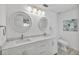 Bathroom features a double vanity, marble counters, and bright lighting for a refreshing space at 6250 Sailboat Ave, Tavares, FL 32778