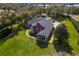 Aerial view of a spacious estate showing mature trees, manicured lawn and extensive driveway at 631 Old Mount Dora Rd, Eustis, FL 32726