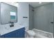 Bathroom featuring updated fixtures, vanity, lighting, and walk in shower at 654 Nw 9Th Ave, Webster, FL 33597