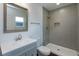 This bathroom has a large shower, decorative tiling, sink with modern fixtures, and a large mirror at 654 Nw 9Th Ave, Webster, FL 33597