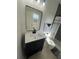 Modern bathroom features a sleek vanity with a white countertop and a black framed mirror at 654 Nw 9Th Ave, Webster, FL 33597