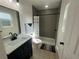 A bathroom features tile flooring, updated fixtures and a shower at 654 Nw 9Th Ave, Webster, FL 33597