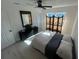 A bright bedroom features wood-look flooring, a screen and decor at 654 Nw 9Th Ave, Webster, FL 33597