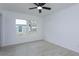 Bedroom with two windows for natural light and ceiling fan with modern flooring at 654 Nw 9Th Ave, Webster, FL 33597