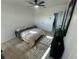 Well-lit bedroom featuring a bed, dresser, and a view to the side yard at 654 Nw 9Th Ave, Webster, FL 33597